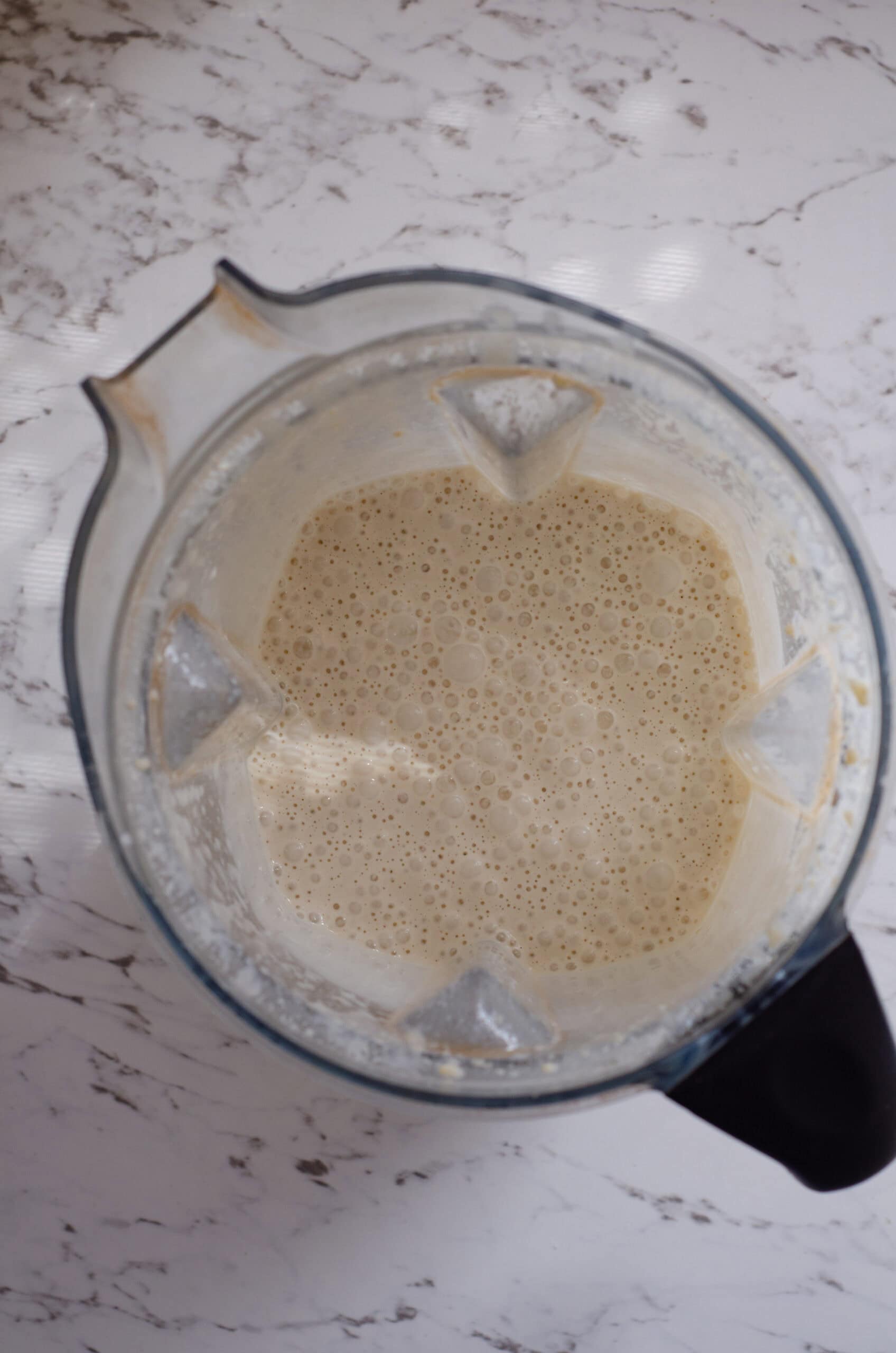 Blended white mixture in a vitamix container.