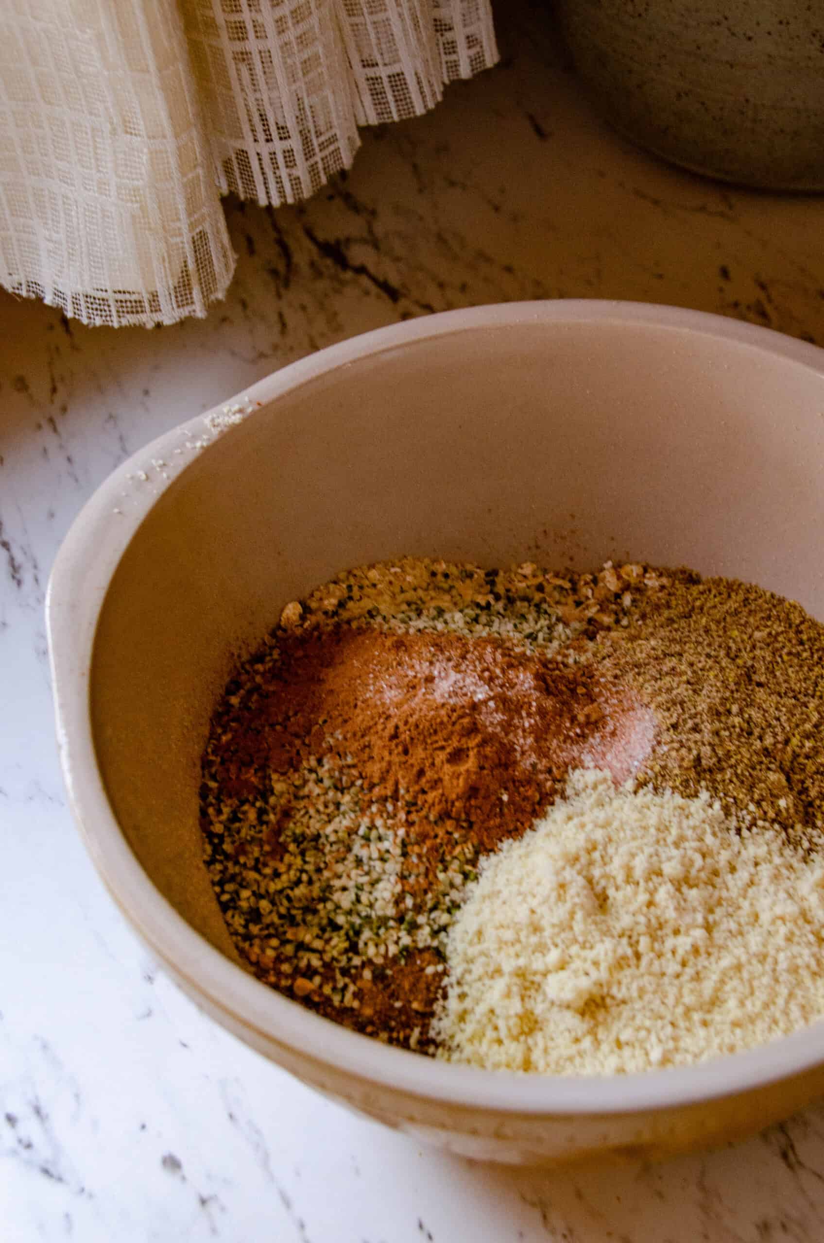 Flour, cinnamon, baking soda, oats, hemp, flax seeds, coconut sugar in a bowl.