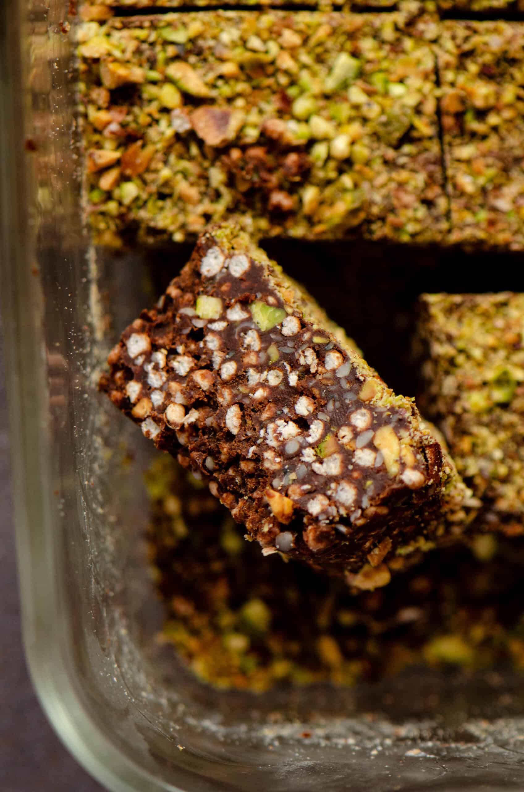 A square sideways in a loaf pan of quinoa chocolate pistachio bars.