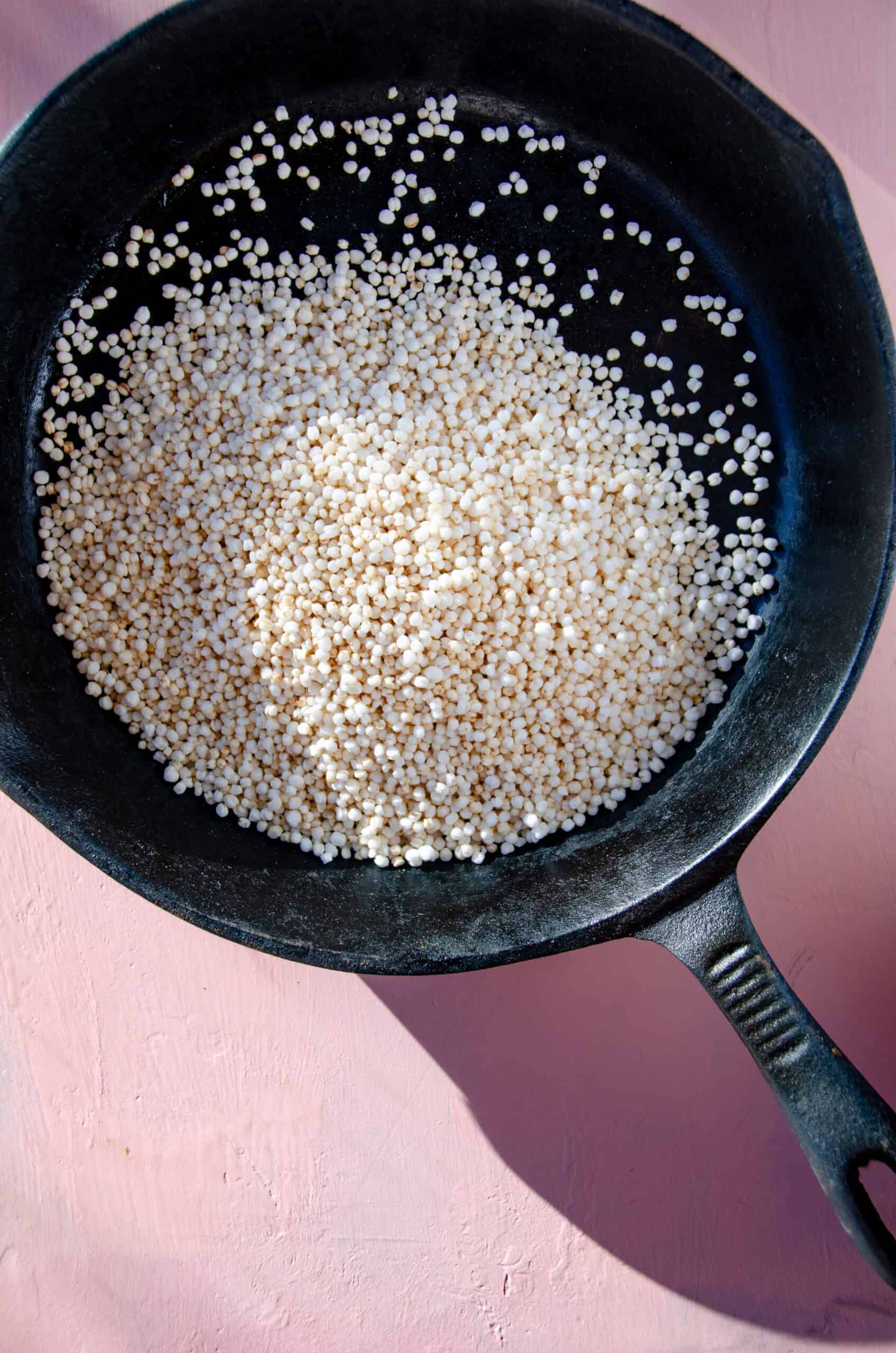Puffed quinoa in a cast iron frying pan.