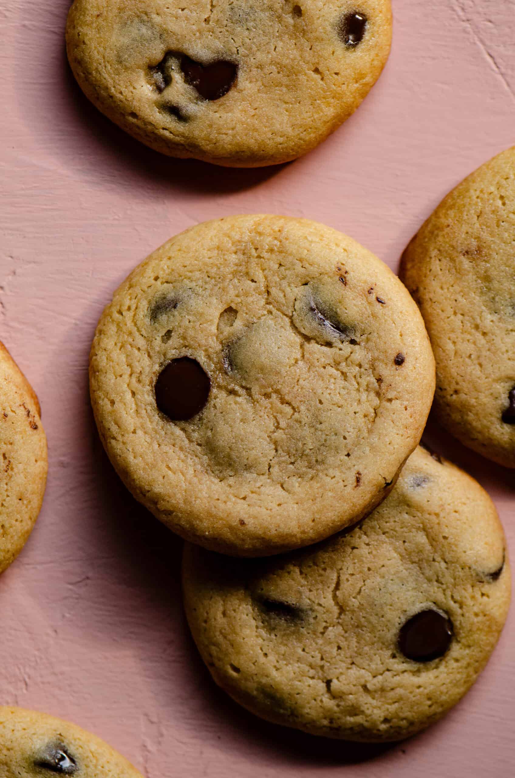 Chocolate chip cookies without sugar on a pink counter.