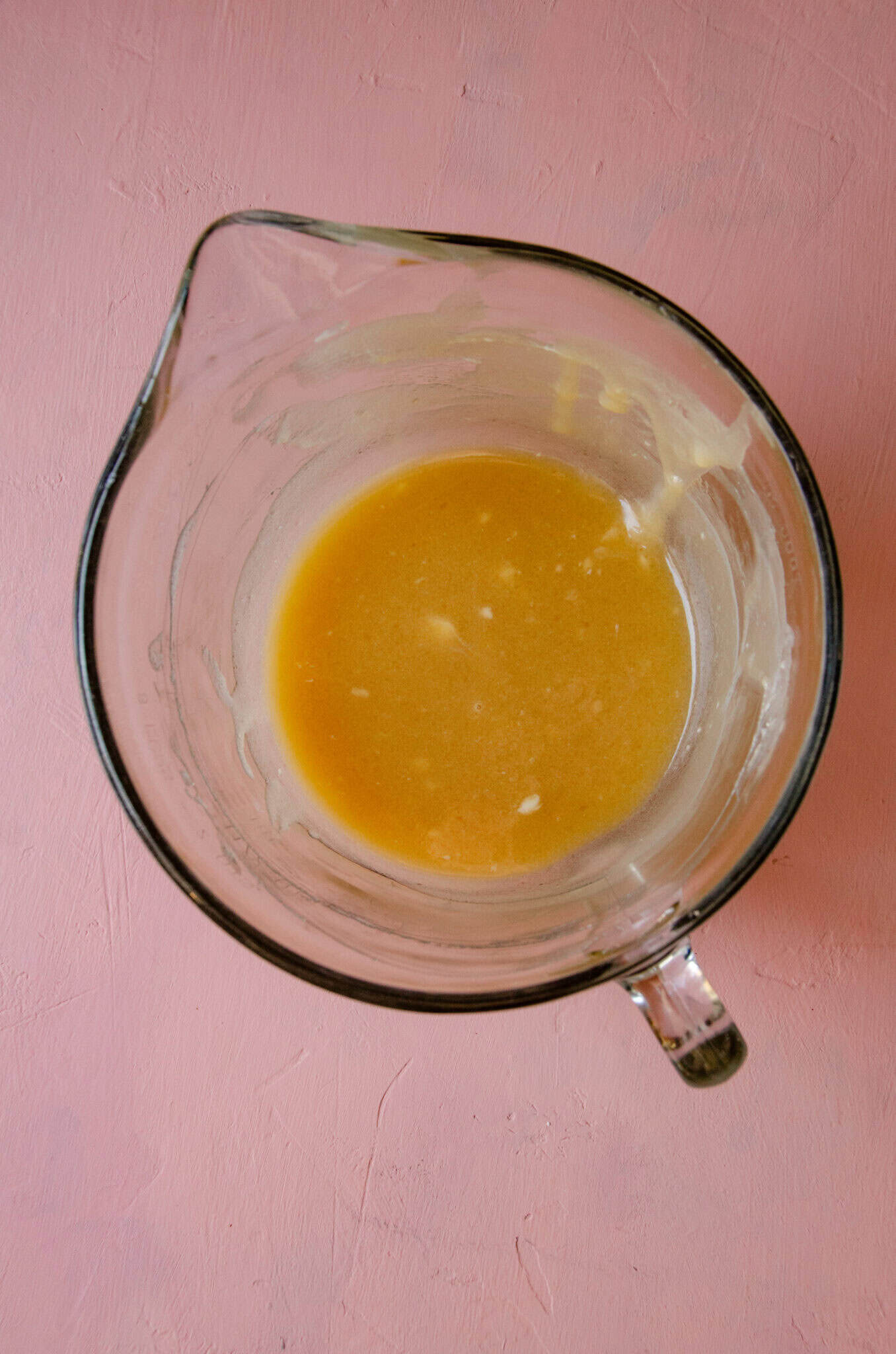 Butter, honey in a glass mixing bowl.