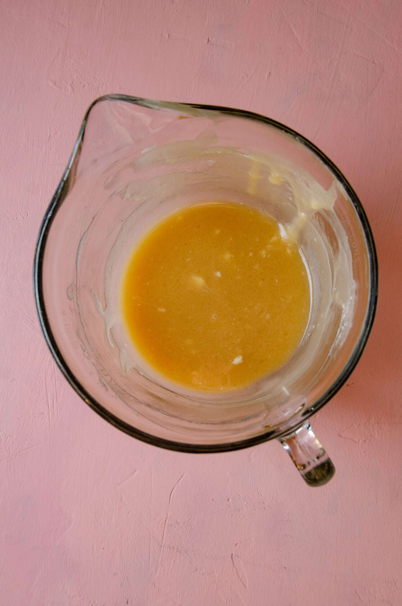 Butter, honey in a glass mixing bowl.