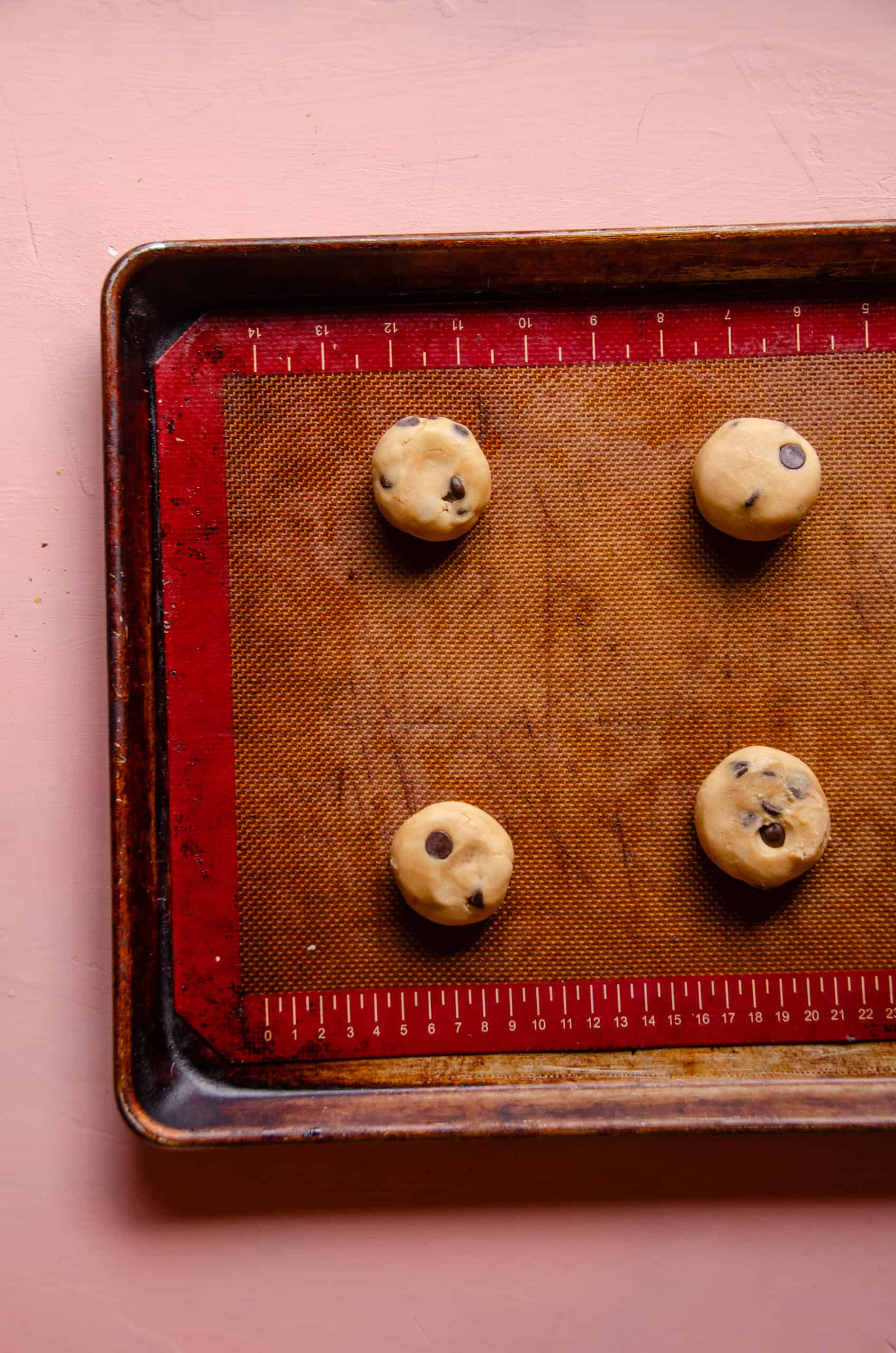 Cookie dough balls on a cookie sheet.
