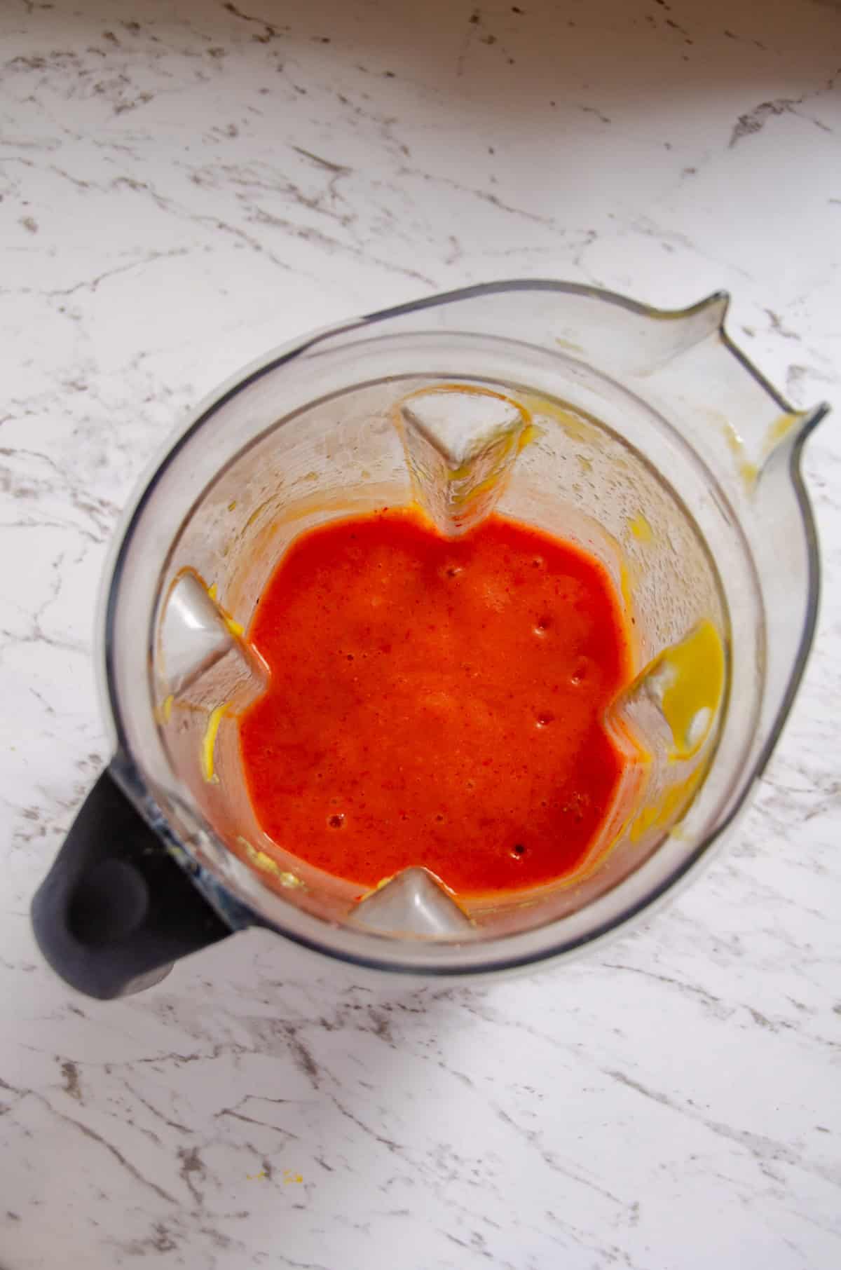 Bright pink puree in a blender container.